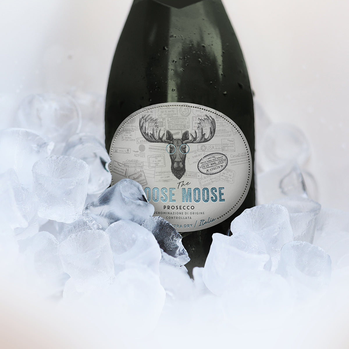 Bottle of 'The Moose' Prosecco surrounded by ice on a white background